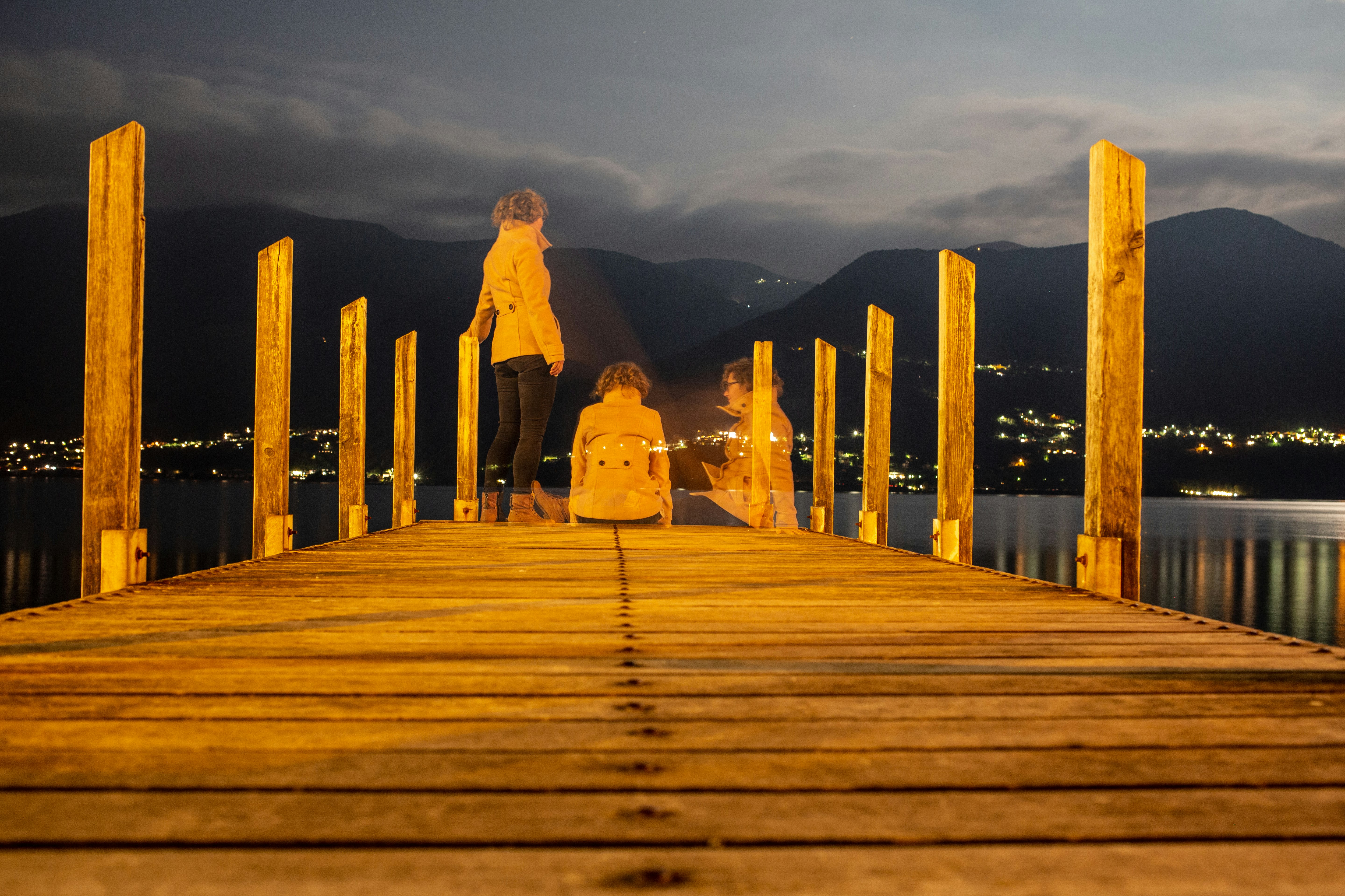 couple walking on wooden dock during daytime